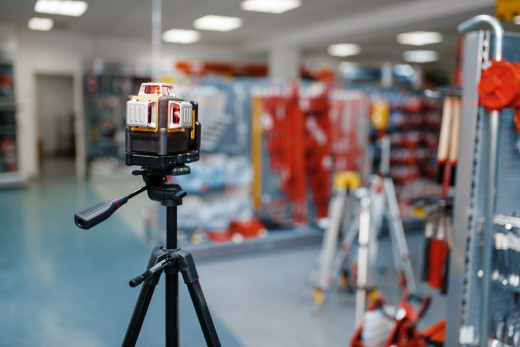 Laser level on tripod in tool store, nobody